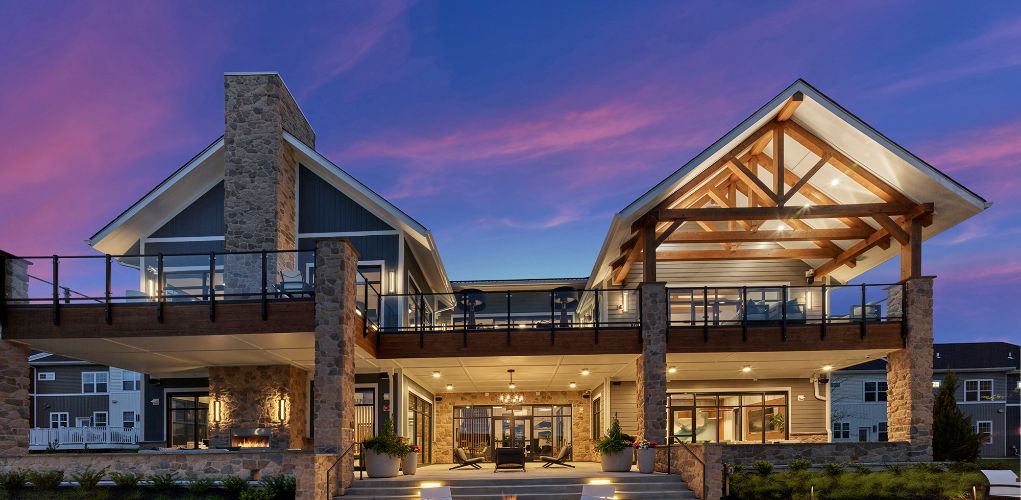 Outdoor view of clubhouse with firepit at dusk	