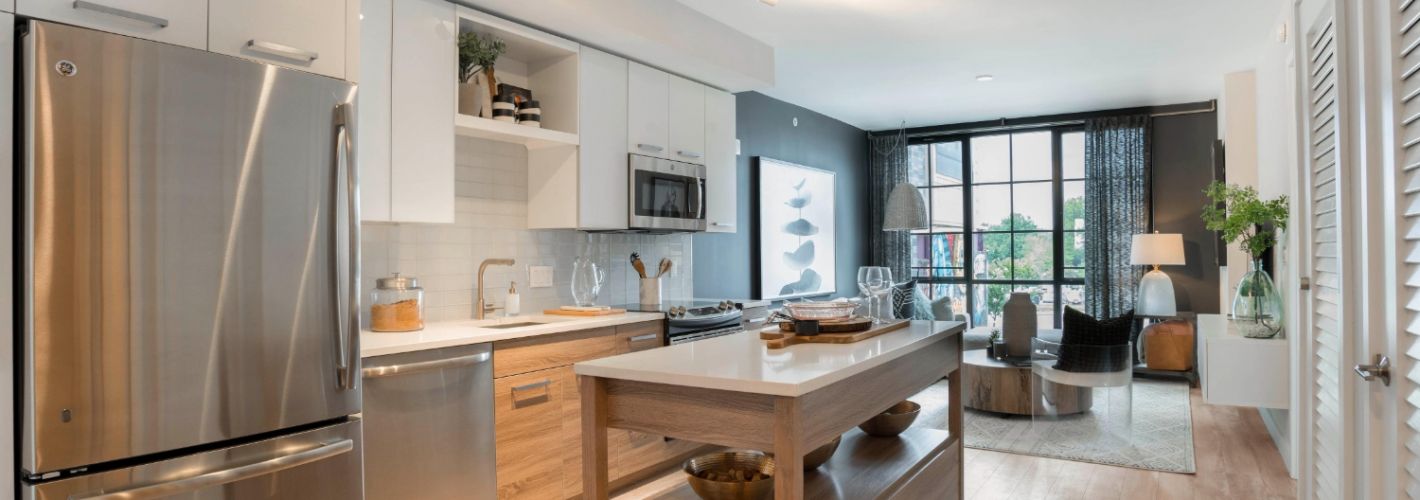 Kitchen with island and view of living room