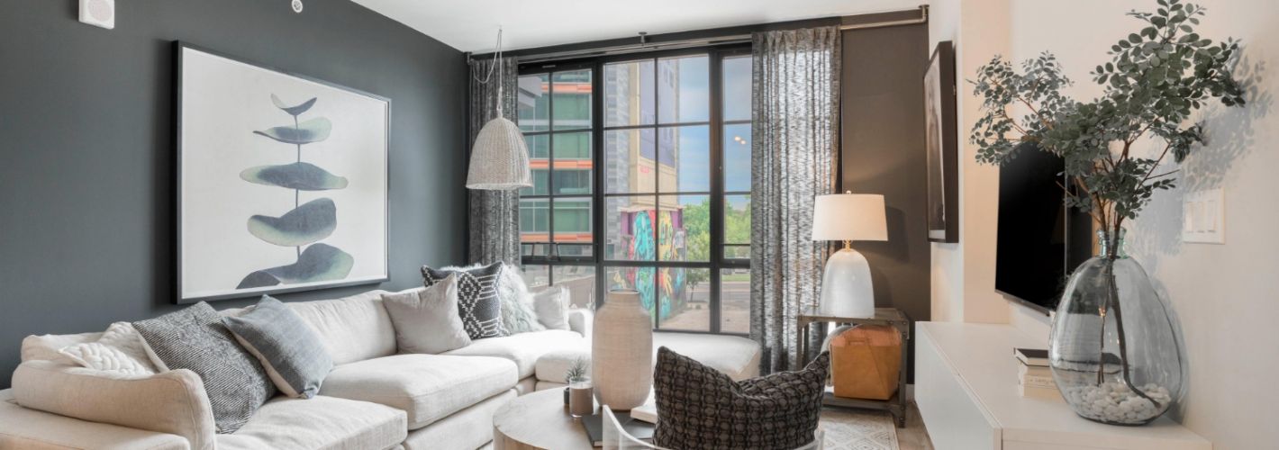 Living room with large couch and floor-to-ceiling windows 