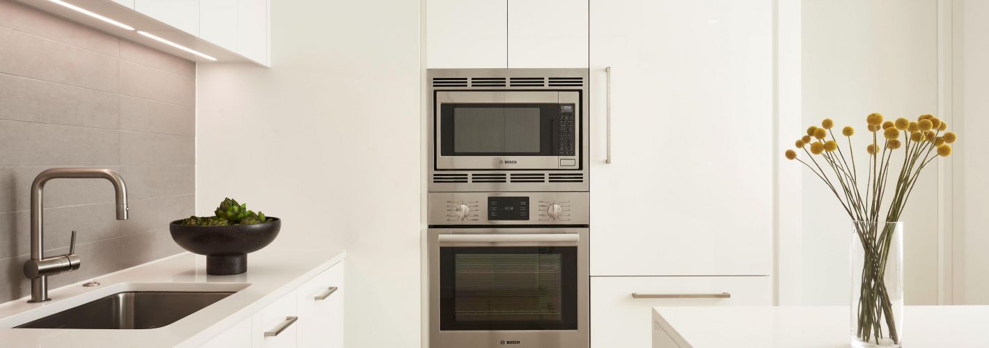 White kitchen featuring stainless steel appliances 