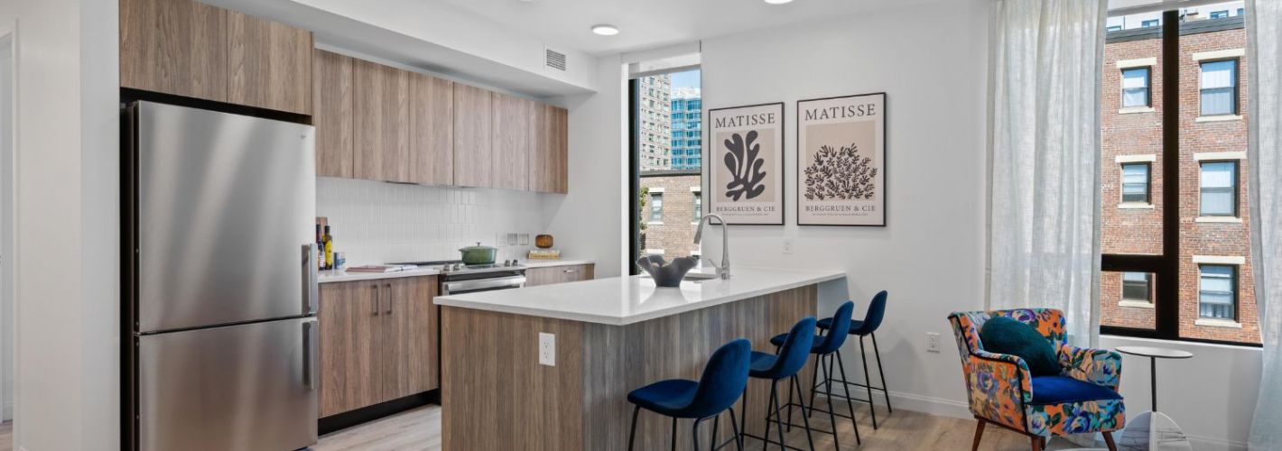 Modern kitchen with bright lighting and sleek appliances.